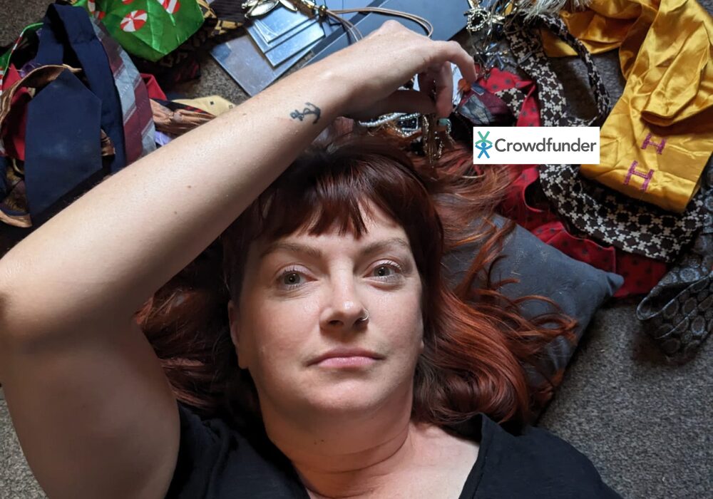 A woman lying on a carpeted floor surrounded by materials