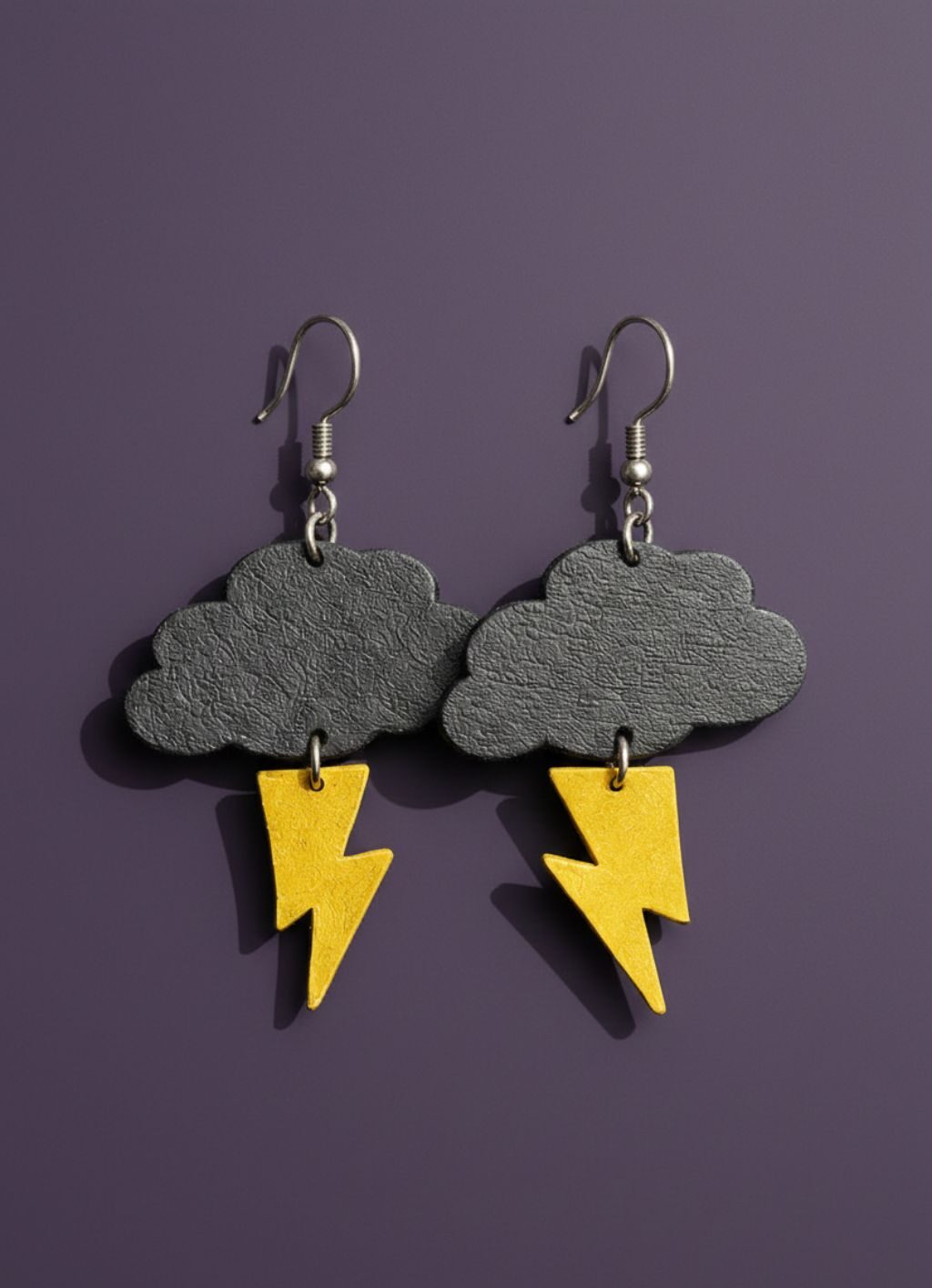 Storm cloud ligtning leather -Trash Panda upcycled jewellery 2026 – Louise Lea (27) A pair of stormcloud earrings - grey clouds and yellow lightning bolts made of upcycled leather